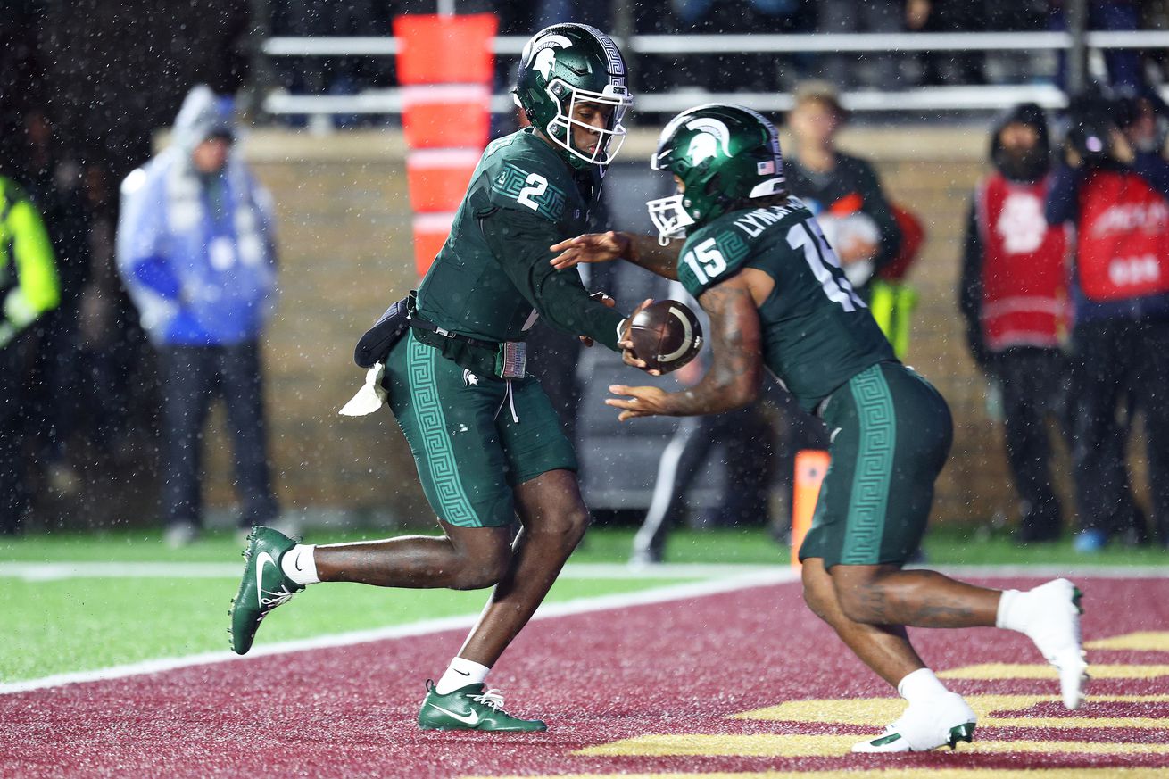 COLLEGE FOOTBALL: SEP 21 Michigan State at Boston College - MSU’s #15 Kay’ron Lynch Adams receives a hand-off from #2 Aiden Chiles in their own end zone.