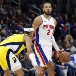 Detroit Pistons guard Cade Cunningham (2) dribbles defended by Indiana Pacers guard Andrew Nembhard (2) in the first half at Little Caesars Arena.