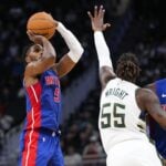 Nov 13, 2024; Milwaukee, Wisconsin, USA; Detroit Pistons guard Malik Beasley (5) shoots against Milwaukee Bucks guard Delon Wright (55) during the third quarter at Fiserv Forum.