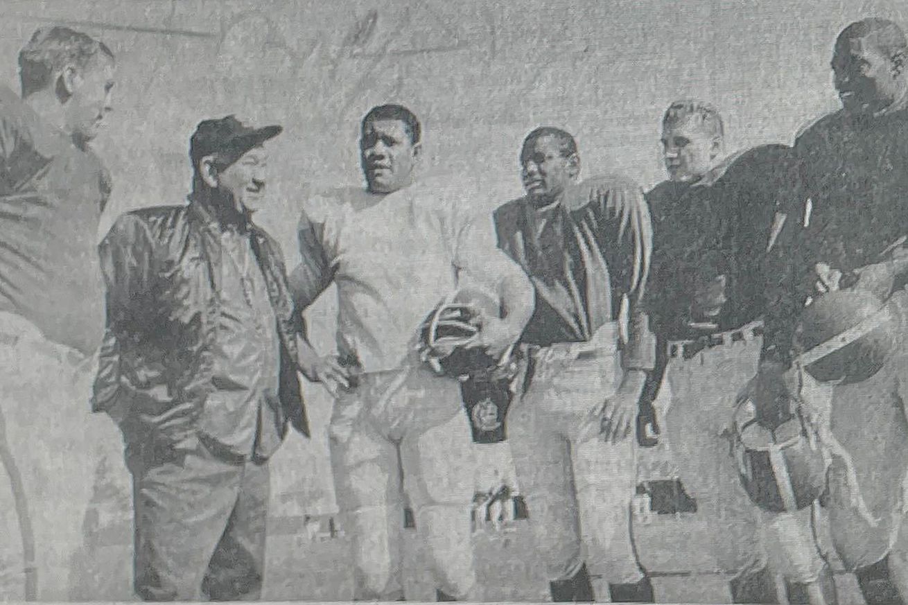Spartan football coach Duffy Daugherty (second from left) is surrounded by top backfield candidates.