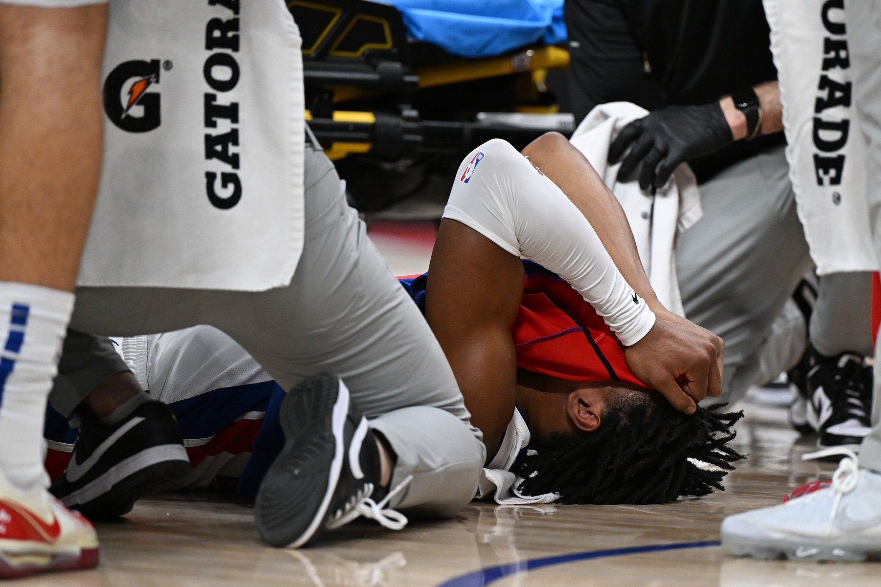 Jan 1, 2025; Detroit, Michigan, USA; Detroit Pistons guard Jaden Ivey (23) grabs his leg as he falls to the court after being injured against the Orlando Magic in the fourth quarter at Little Caesars Arena.