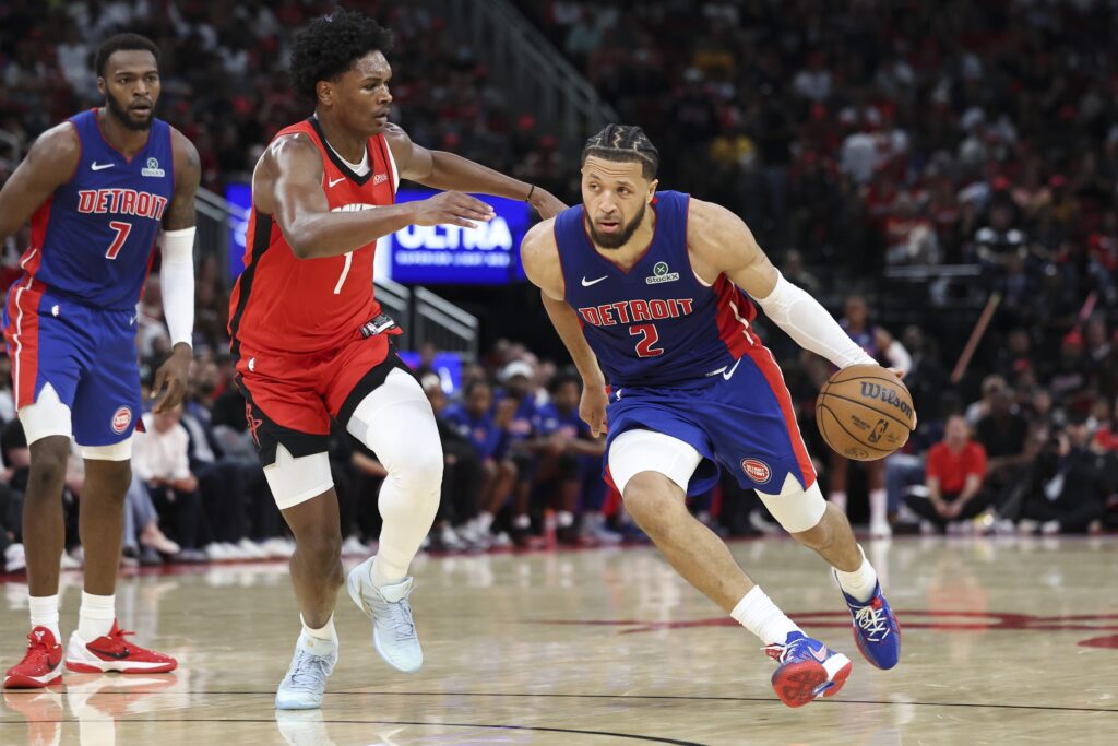 Detroit Pistons guard Cade Cunningham (2) dribbles the ball as Houston Rockets guard Amen Thompson (1) defends during the fourth quarter at Toyota Center.
