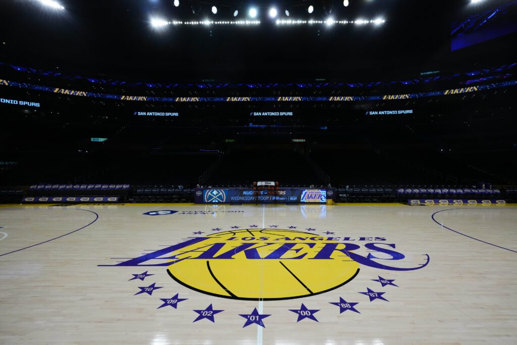 The Los Angeles Lakers logo at midcourt at Crypto.com Arena.
