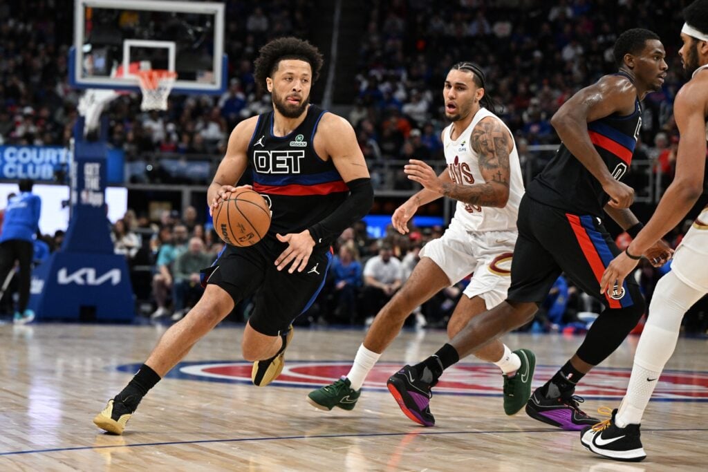 Feb 27, 2026; Detroit, Michigan, USA; Detroit Pistons guard Cade Cunningham (2) drive past Cleveland Cavaliers guard Jaylon Tyson (20) in the first half at Little Caesars Arena. Mandatory Credit: Lon Horwedel-Imagn Images